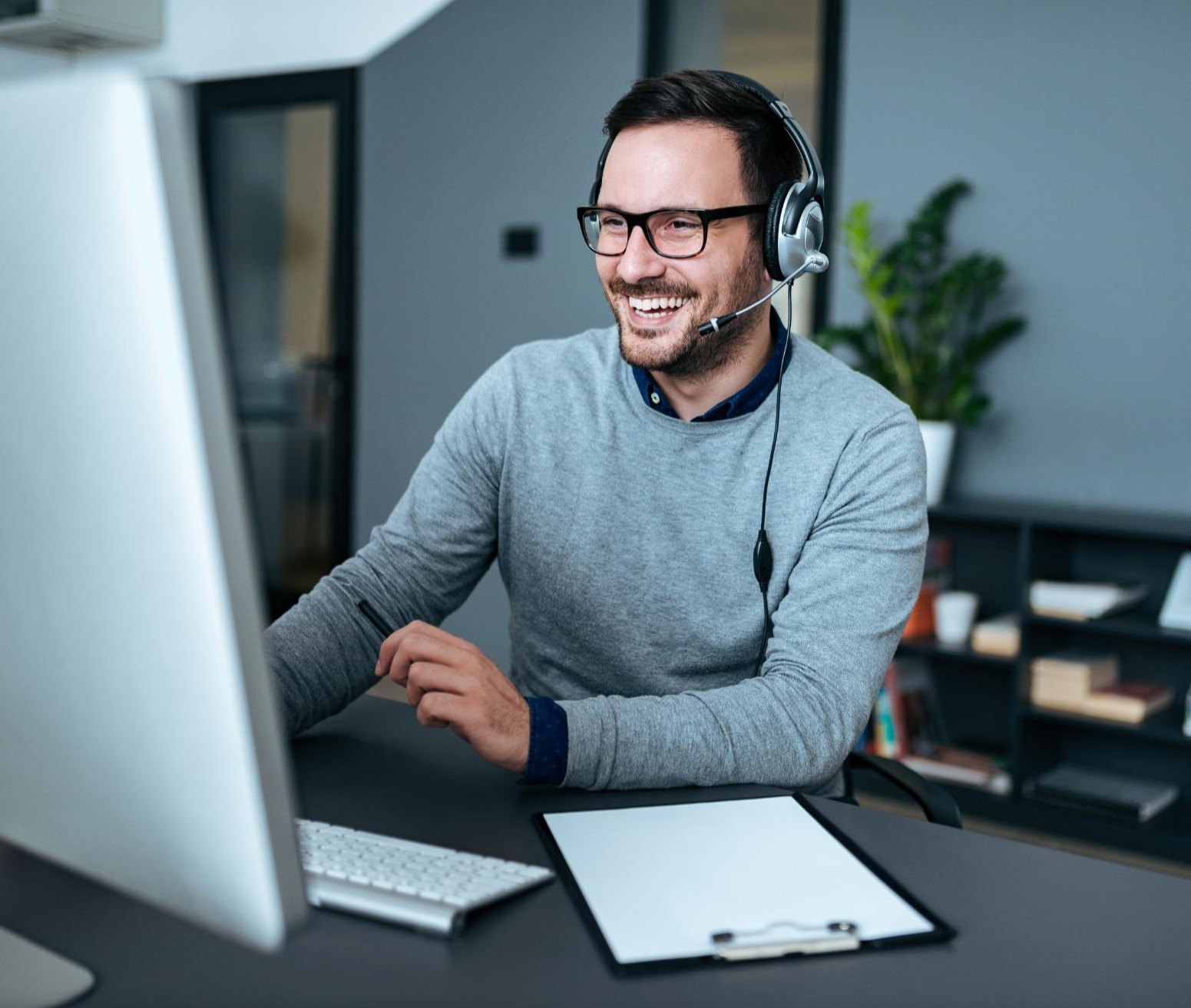 business professional using a headset during a customer call in a modern office environment