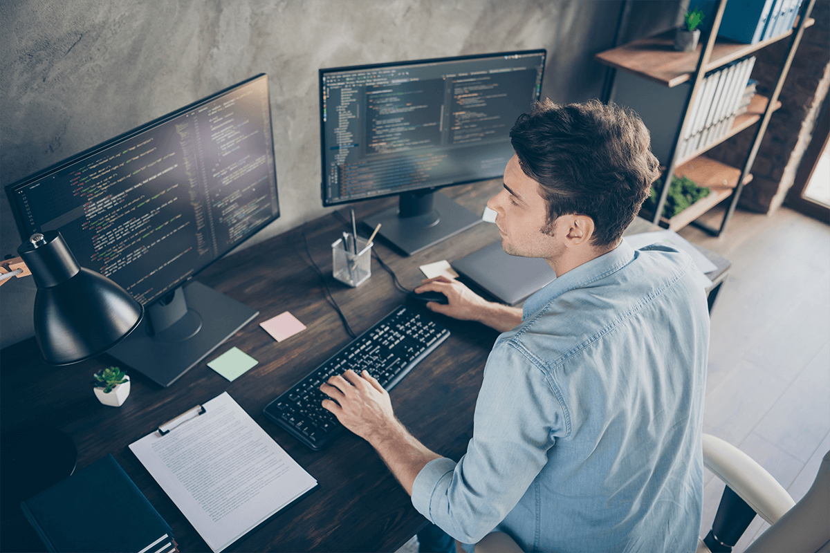 man at computer analyzing code